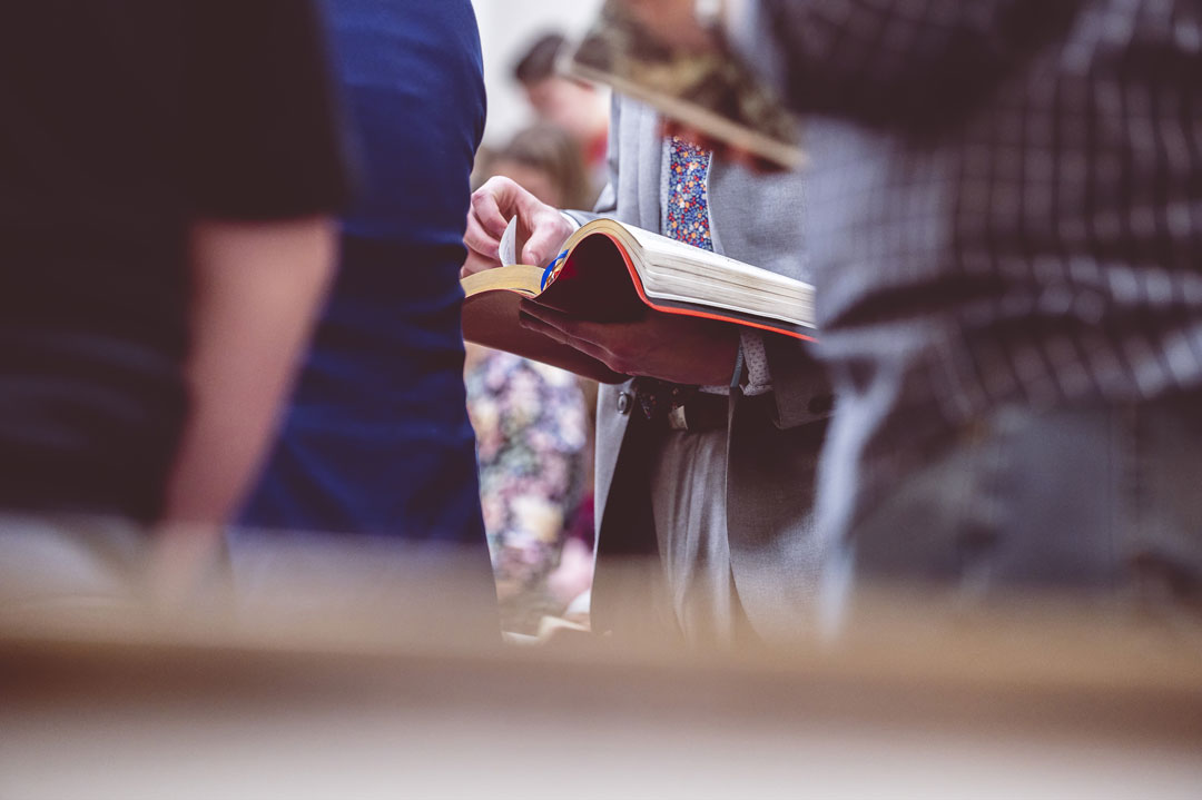 woman-reading-the-bible-during-a-church-gathering-2023-11-27-04-59-39-utc